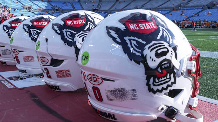 Sep 7, 2024; Charlotte, North Carolina, USA; North Carolina State Wolfpack helmets during pregame activity for the Dukes Mayo Classic against the Tennessee Volunteers at Bank of America Stadium. Mandatory Credit: Jim Dedmon-Imagn Images Sep 7, 2024; Charlotte, North Carolina, USA; North Carolina State Wolfpack helmets during pregame activity for the Dukes Mayo Classic against the Tennessee Volunteers at Bank of America Stadium. Mandatory Credit: Jim Dedmon-Imagn Images