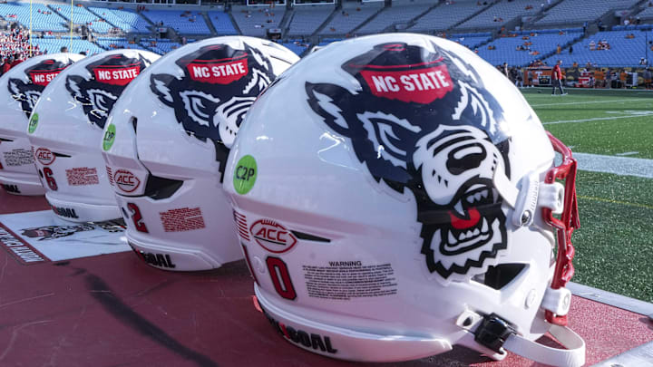 Sep 7, 2024; Charlotte, North Carolina, USA; North Carolina State Wolfpack helmets during pregame activity for the Dukes Mayo Classic against the Tennessee Volunteers at Bank of America Stadium. Mandatory Credit: Jim Dedmon-Imagn Images