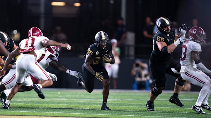 Vanderbilt Commodores running back Sedrick Alexander (28) hits a hole against the Alabama Crimson Tide during their game at Vanderbilt Stadium in Nashville, Tenn., Saturday, Oct. 5, 2024.