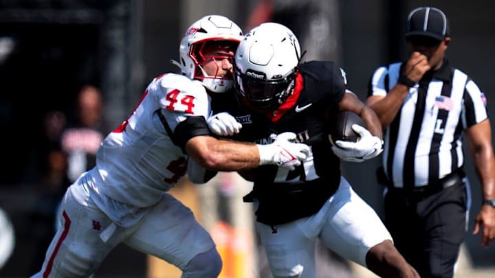Houston Cougars linebacker Michael Batton (44) tackles Cincinnati Bearcats running back Corey Kiner (21) in the second quarter of the College Football game at Nippert Stadium in Cincinnati on Saturday, Sept. 21, 2024.