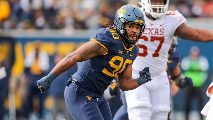 Nov 20, 2021; Morgantown, West Virginia, USA; West Virginia Mountaineers defensive lineman Akheem Mesidor (90) chases Texas Longhorns quarterback Hudson Card (1) during the third quarter at Mountaineer Field at Milan Puskar Stadium. Mandatory Credit: Ben Queen-Imagn Images