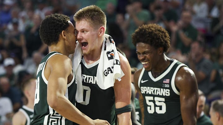 Nov 25, 2025; Fort Myers, Florida, USA; Michigan State Spartans forward Jaxon Kohler (0) reacts to guard Divine Ugochukwu (99) after a basket against the East Carolina Pirates in the first half at Suncoast Credit Union Arena. Nov 25, 2025; Fort Myers, Florida, USA; Michigan State Spartans forward Jaxon Kohler (0) reacts to guard Divine Ugochukwu (99) after a basket against the East Carolina Pirates in the first half at Suncoast Credit Union Arena.