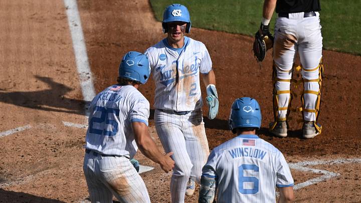 May 31, 2026; Chapel Hill, NC, USA; North Carolina Tar Heels infielder Jake Schaffner (2) is greeted at the plate after scoring by outfielder Rom Kellis (25) and catcher MacOn Winslow (6) against the East Carolina Pirates during the Chapel Hill Regional at Boshamer Stadium. Mandatory Credit: William Howard-Imagn Images