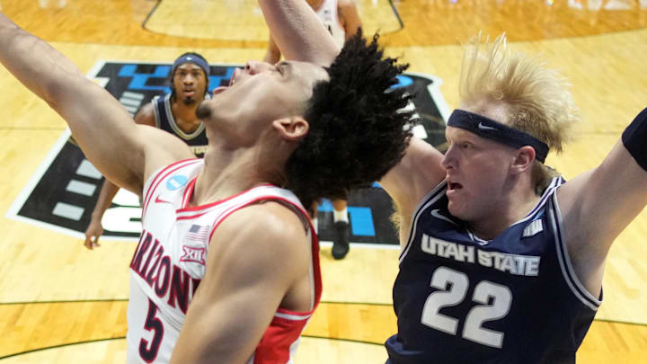 Mar 22, 2026; San Diego, CA, USA; Arizona Wildcats guard Brayden Burries (5) shoots against Utah State Aggies guard Mason Falslev (12) and forward Karson Templin (22) in the first half during a second round game of the men's 2026 NCAA Tournament at Viejas Arena. Mandatory Credit: Kirby Lee-Imagn Images Mar 22, 2026; San Diego, CA, USA; Arizona Wildcats guard Brayden Burries (5) shoots against Utah State Aggies guard Mason Falslev (12) and forward Karson Templin (22) in the first half during a second round game of the men's 2026 NCAA Tournament at Viejas Arena. Mandatory Credit: Kirby Lee-Imagn Images