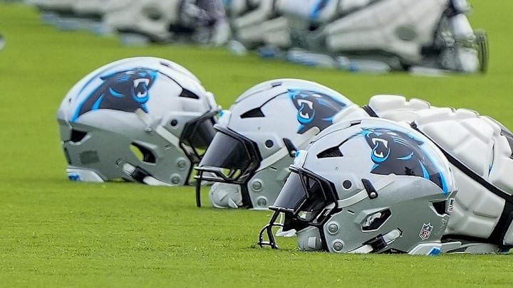 Jul 30, 2024; Charlotte, NC, USA; Carolina Panthers helmets at Carolina Panthers Practice Fields. Mandatory Credit: Jim Dedmon-Imagn Images Jul 30, 2024; Charlotte, NC, USA; Carolina Panthers helmets at Carolina Panthers Practice Fields. Mandatory Credit: Jim Dedmon-Imagn Images