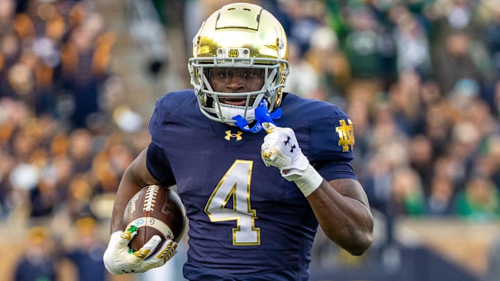 Nov 22, 2025; South Bend, Indiana, USA; Notre Dame Fighting Irish running back Jeremiyah Love (4) runs the ball against the Syracuse Orange during the first half at Notre Dame Stadium. Mandatory Credit: Michael Caterina-Imagn Images