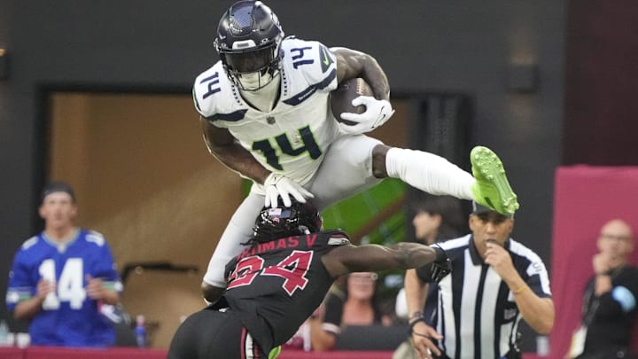 Seattle Seahawks wide receiver DK Metcalf (14) jumps over Arizona Cardinals cornerback Starling Thomas V (24) during the second quarter at State Farm Stadium in Glendale on Dec. 8, 2024. Seattle Seahawks wide receiver DK Metcalf (14) jumps over Arizona Cardinals cornerback Starling Thomas V (24) during the second quarter at State Farm Stadium in Glendale on Dec. 8, 2024.