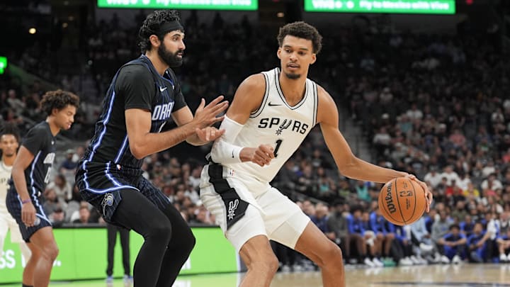 Oct 9, 2024; San Antonio, Texas, USA; San Antonio Spurs center Victor Wembanyama (1) backs in against Orlando Magic center Goga Bitadze (35) in the first half at Frost Bank Center.