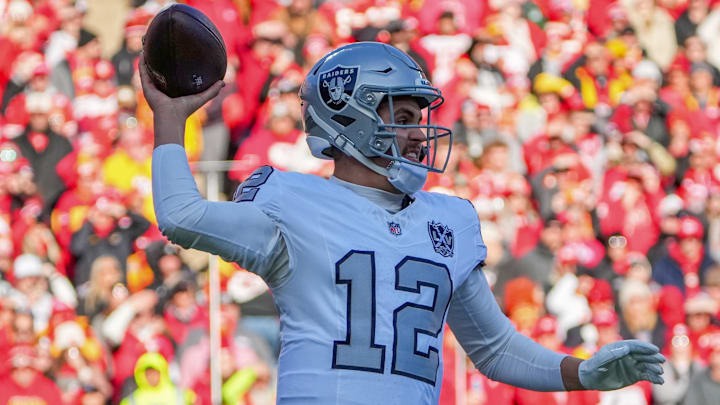 Nov 29, 2024; Kansas City, Missouri, USA; Las Vegas Raiders quarterback Aidan O'Connell (12) throws a pass against the Kansas City Chiefs during the first half at GEHA Field at Arrowhead Stadium. Mandatory Credit: Denny Medley-Imagn Images