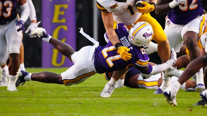 Sep 14, 2024; Greenville, North Carolina, USA;  Appalachian State Mountaineers running back Anderson Castle (1) is stopped on his run by East Carolina Pirates defensive back Ja'Marley Riddle (22) during the second half at Dowdy-Ficklen Stadium. Mandatory Credit: James Guillory-Imagn Images