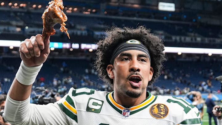 Green Bay Packers quarterback Jordan Love (10) waves at fans as he exits the field with turkey leg on Thursday.