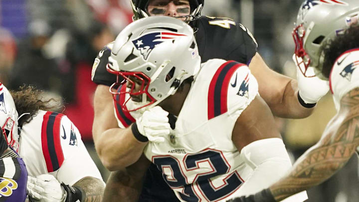 Dec 21, 2025; Baltimore, Maryland, USA;  Baltimore Ravens running back Derrick Henry (22) runs the ball against New England Patriots linebacker Harold Landry III (2) and defensive tackle Joshua Farmer (92) during the first quarter of the game at M&T Bank Stadium. Mandatory Credit: Mitch Stringer-Imagn Images
