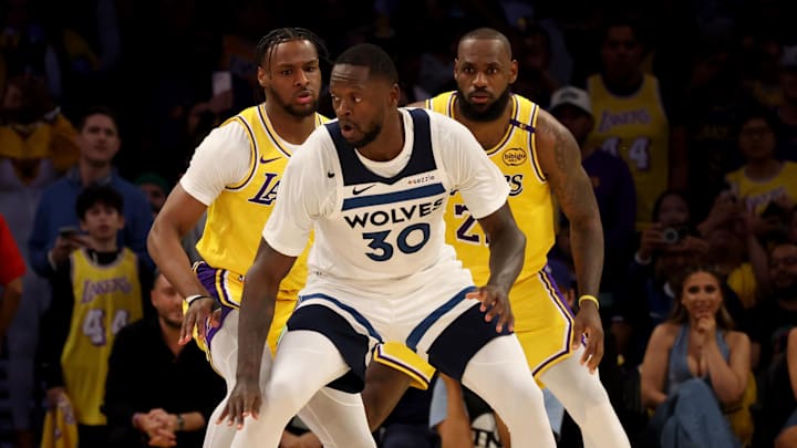 Oct 22, 2024; Los Angeles, California, USA; Los Angeles Lakers guard Bronny James (9) and forward LeBron James (23) guard Minnesota Timberwolves forward Julius Randle (30) during the second quarter against the Minnesota Timberwolves at Crypto.com Arena. This marked the first time in NBA history that a father and son played together. Mandatory Credit: Jason Parkhurst-Imagn Images