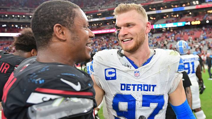 Sep 22, 2024; Glendale, Arizona, USA;  Detroit Lions defensive end Aidan Hutchinson (97) and Arizona Cardinals linebacker Julian Okwara (58) talk after the game at State Farm Stadium. Mandatory Credit: Matt Kartozian-Imagn Images