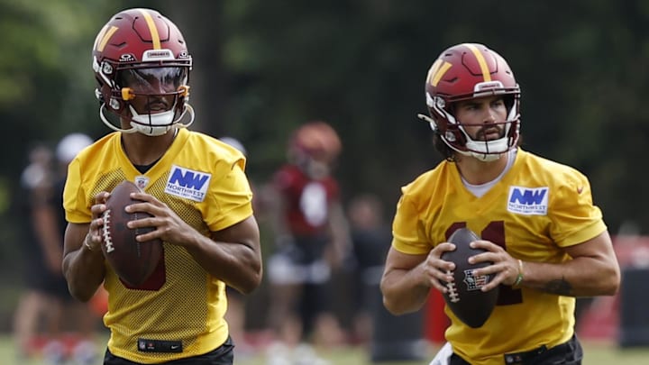 Jul 26, 2024; Ashburn, VA, USA; Washington Commanders quarterback Jayden Daniels (5) and Commanders quarterback Sam Hartman (11) drop back to pass as Washington Commanders quarterback Marcus Mariota (0) looks on during day three of training camp at Commanders Park. Mandatory Credit: Geoff Burke-Imagn Images Jul 26, 2024; Ashburn, VA, USA; Washington Commanders quarterback Jayden Daniels (5) and Commanders quarterback Sam Hartman (11) drop back to pass as Washington Commanders quarterback Marcus Mariota (0) looks on during day three of training camp at Commanders Park. Mandatory Credit: Geoff Burke-Imagn Images