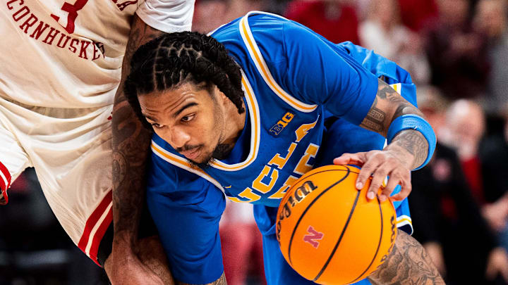 Jan 4, 2025; Lincoln, Nebraska, USA; UCLA Bruins guard Skyy Clark (55) drives against Nebraska Cornhuskers guard Brice Williams (3) during the second half at Pinnacle Bank Arena. Mandatory Credit: Dylan Widger-Imagn Images