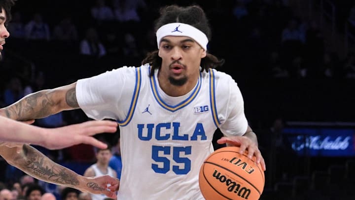 Dec 21, 2024; New York, NY, USA; UCLA Bruins guard Skyy Clark (55) drives to the basket while being defended by North Carolina Tar Heels guard Elliot Cadeau (3) during the first half at Madison Square Garden. Mandatory Credit: John Jones-Imagn Images