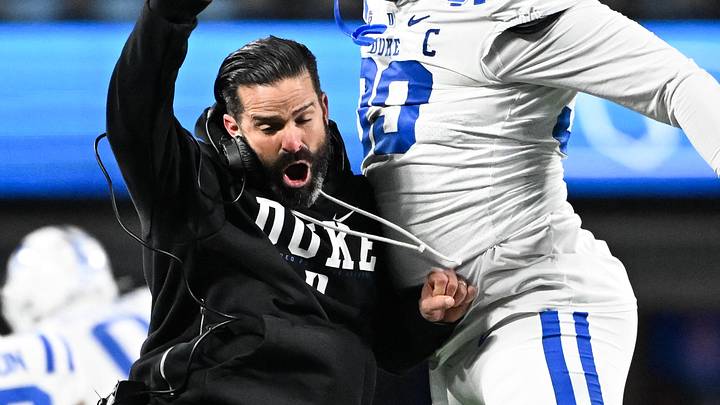Dec 6, 2025; Charlotte, NC, USA; Duke Blue Devils head coach Manny Diaz reacts with defensive tackle Aaron Hall (99) in the first quarter against the Virginia Cavaliers during the 2025 ACC Championship game at Bank of America Stadium. Mandatory Credit: Bob Donnan-Imagn Images Dec 6, 2025; Charlotte, NC, USA; Duke Blue Devils head coach Manny Diaz reacts with defensive tackle Aaron Hall (99) in the first quarter against the Virginia Cavaliers during the 2025 ACC Championship game at Bank of America Stadium. Mandatory Credit: Bob Donnan-Imagn Images