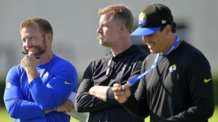 Jul 29, 2024; Los Angeles, CA, USA; Los Angeles Rams head coach Sean McVay, general manager Les Snead and chief of staff Carter Crutchfield talk on the field during training camp at Loyola Marymount University. Mandatory Credit: Jayne Kamin-Oncea-Imagn Images