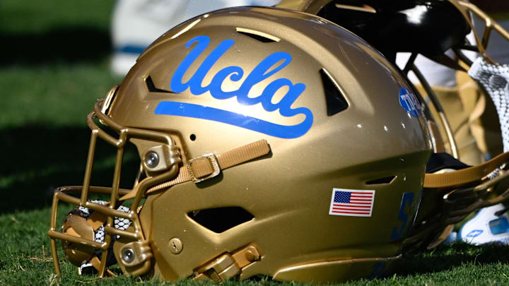 Nov 30, 2024; Pasadena, California, USA; UCLA Bruins helmets during pregame warmups before playing the Fresno State Bulldogs at Rose Bowl. Mandatory Credit: Robert Hanashiro-Imagn Images