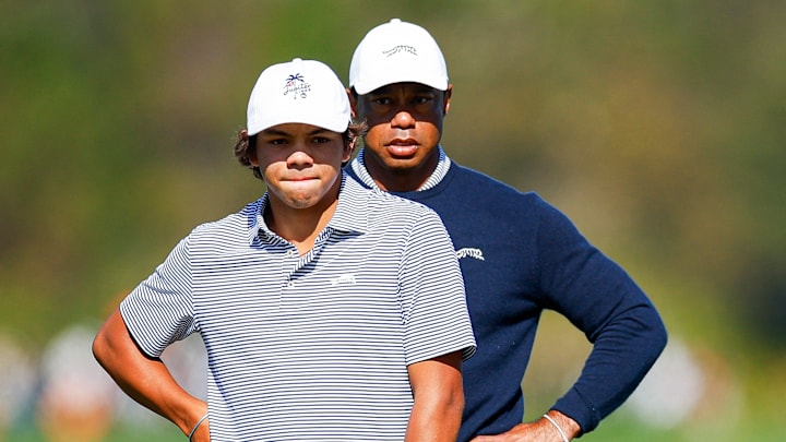 Tiger Woods and his son Charlie Woods look over a putt on the fifth hole during the first round of the 2024 PNC Championship.