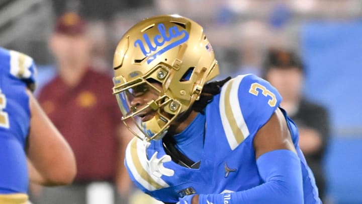 Oct 12, 2024; Pasadena, California, USA; UCLA Bruins wide receiver Kwazi Gilmer (3) runs past Minnesota Golden Gophers defensive lineman Deven Eastern (91) during the second quarter at the Rose Bowl. Mandatory Credit: Robert Hanashiro-Imagn Images