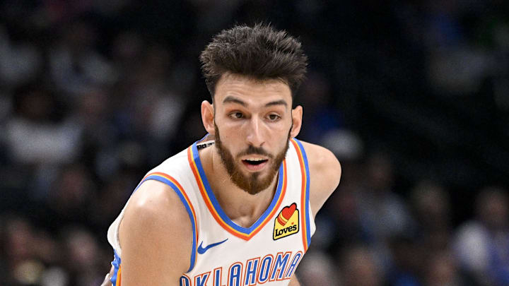 Oct 27, 2025; Dallas, Texas, USA; Oklahoma City Thunder center Chet Holmgren (7) looks to move the ball past Dallas Mavericks forward Naji Marshall (13) during the second quarter at the American Airlines Center. Mandatory Credit: Jerome Miron-Imagn Images