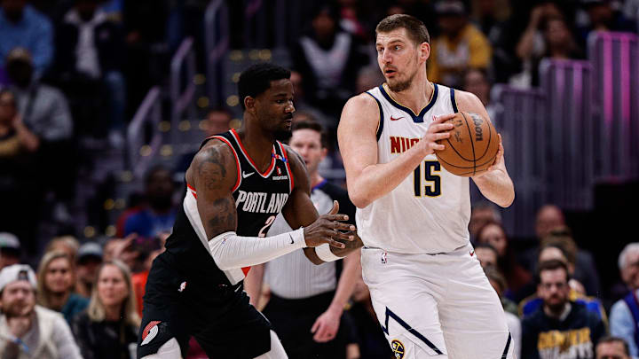 Feb 10, 2025; Denver, Colorado, USA; Denver Nuggets center Nikola Jokic (15) controls the ball as Portland Trail Blazers center Deandre Ayton (2) guards in the first quarter at Ball Arena. Mandatory Credit: Isaiah J. Downing-Imagn Images