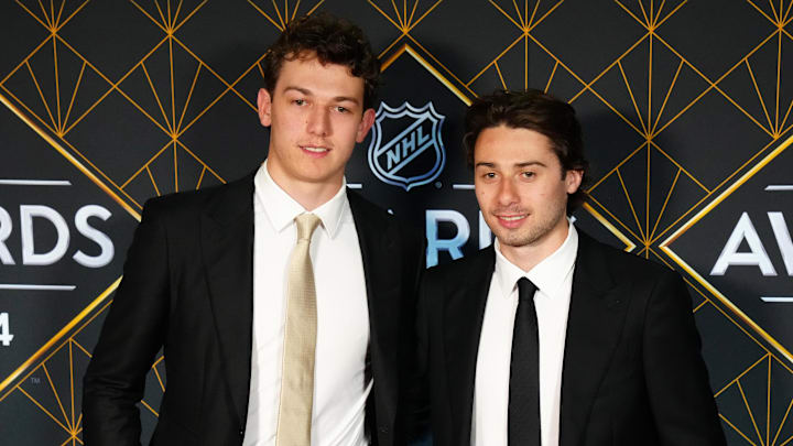 Jun 27, 2024; Las Vegas, Nevada, USA; Luke and Quinn Hughes appear on a red carpet before the start of the 2024 NHL Awards at Fontainebleau Las Vegas. Mandatory Credit: Stephen R. Sylvanie-Imagn Images