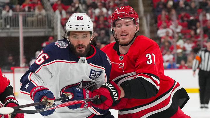Dec 9, 2025; Raleigh, North Carolina, USA;  Carolina Hurricanes right wing Andrei Svechnikov (37) and Columbus Blue Jackets right wing Kirill Marchenko (86) watch the play during the second period at Lenovo Center. Mandatory Credit: James Guillory-Imagn Images