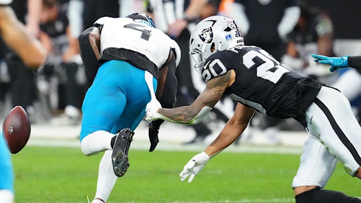 Dec 22, 2024; Paradise, Nevada, USA; Las Vegas Raiders safety Isaiah Pola-Mao (20) causes Jacksonville Jaguars running back Tank Bigsby (4) to fumble during the second quarter at Allegiant Stadium. Mandatory Credit: Stephen R. Sylvanie-Imagn Images