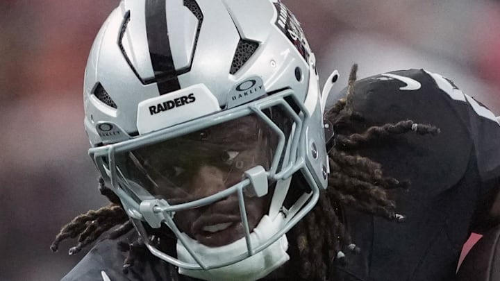 Jan 4, 2026; Paradise, Nevada, USA; Las Vegas Raiders running back Ashton Jeanty (2) carries the ball against Kansas City Chiefs linebacker Drue Tranquill (23) in the first half at Allegiant Stadium. Mandatory Credit: Kirby Lee-Imagn Images