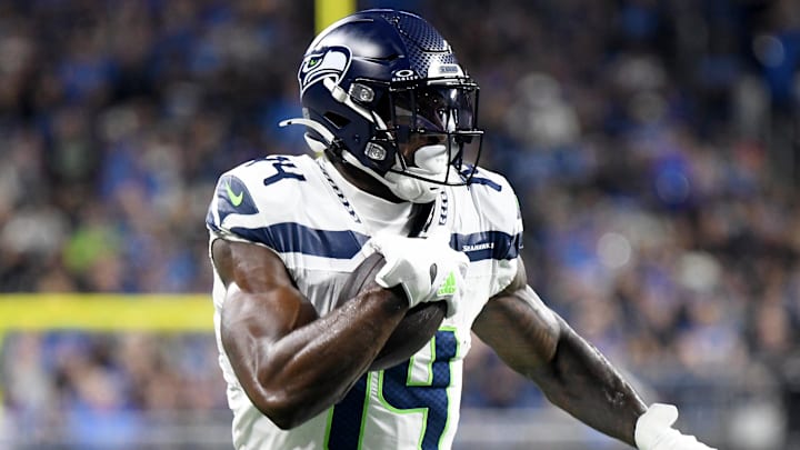 Sep 30, 2024; Detroit, Michigan, USA; Seattle Seahawks wide receiver DK Metcalf (14) runs with the ball against the Detroit Lions in the second quarter at Ford Field. Mandatory Credit: Eamon Horwedel-Imagn Images