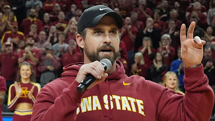 Iowa State football coach Jimmy Rogers speaks during a timeout in the Cy-Hawk men's basketball game on Dec. 11, 2025, at Hilton Coliseum in Ames. Iowa State football coach Jimmy Rogers speaks during a timeout in the Cy-Hawk men's basketball game on Dec. 11, 2025, at Hilton Coliseum in Ames.
