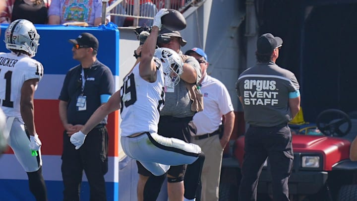 Oct 6, 2024; Denver, Colorado, USA; Las Vegas Raiders tight end Brock Bowers (89) spikes the ball after his touchdown reception in the first quarter against the Denver Broncos at Empower Field at Mile High. Mandatory Credit: Ron Chenoy-Imagn Images