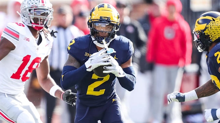 Nov 25, 2023; Ann Arbor, MI, USA;  Michigan defensive back Will Johnson intercepts a pass intended for Ohio State wide receiver Marvin Harrison Jr. during the first half at Michigan Stadium in Ann Arbor on Saturday, Nov. 25, 2023. Mandatory Credit: Junfu Han-Imagn Images