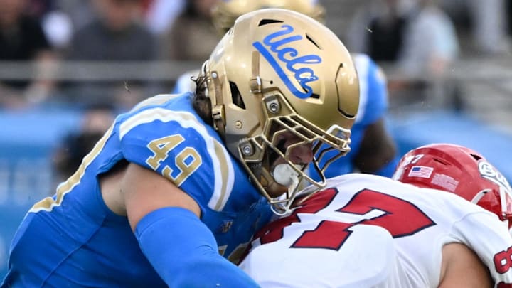Nov 30, 2024; Pasadena, California, USA; UCLA Bruins linebacker Carson Schwesinger (49) Fresno State Bulldogs tight end Jake Tarwater (87) during the third quarter at Rose Bowl. Mandatory Credit: Robert Hanashiro-Imagn Images