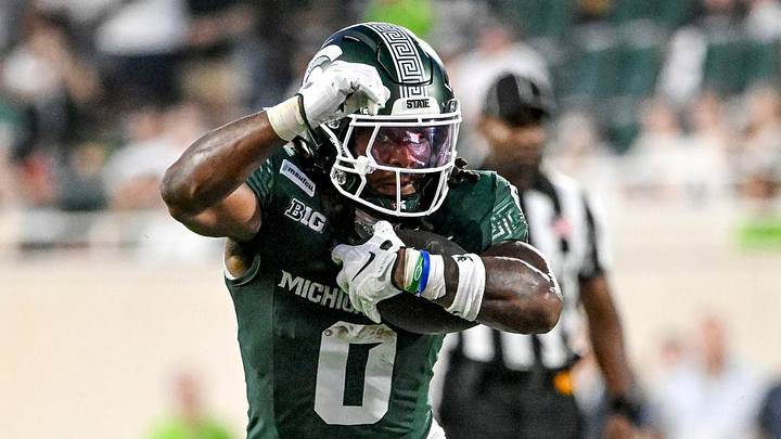 Michigan State’s Cam Edwards runs for a gain as Toledo’s Mo Conteh closes in during the first quarter on Friday, Sept. 4, 2026, at Spartan Stadium in East Lansing. Michigan State’s Cam Edwards runs for a gain as Toledo’s Mo Conteh closes in during the first quarter on Friday, Sept. 4, 2026, at Spartan Stadium in East Lansing.