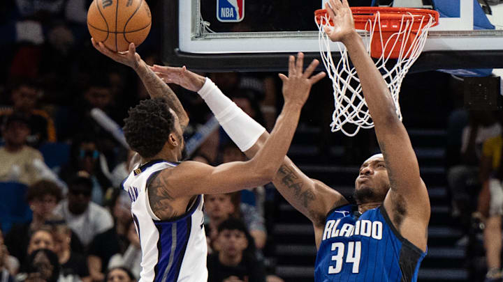 Mar 29, 2025; Orlando, Florida, USA; Sacramento Kings guard/forward DeMar DeRozan (10) shoots the ball over Orlando Magic forward Wendell Carter Jr. (34) in the third quarter at Kia Center. Mandatory Credit: Jeremy Reper-Imagn Images