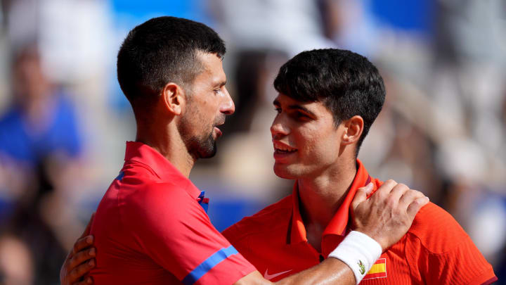 Aug 4, 2024; Paris, France; Novak Djokovic (SRB) greets Carlos Alcaraz (ESP) after winning the men’s singles gold medal match during the Paris 2024 Olympic Summer Games at Stade Roland Garros. 