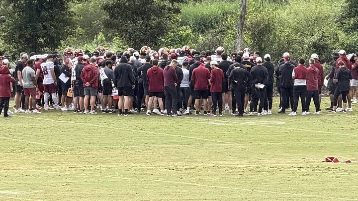 Washington Commanders players and coaches gather during Wednesday’s training camp practice in Ashburn, Virginia. Washington Commanders players and coaches gather during Wednesday’s training camp practice in Ashburn, Virginia.