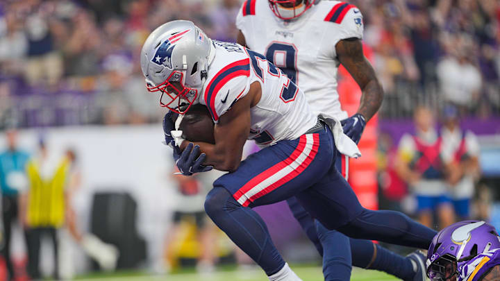 Aug 16, 2025; Minneapolis, Minnesota, USA; New England Patriots running back TreVeyon Henderson (32) scores a touchdown against the Minnesota Vikings in the first quarter at U.S. Bank Stadium. Mandatory Credit: Brad Rempel-Imagn Images