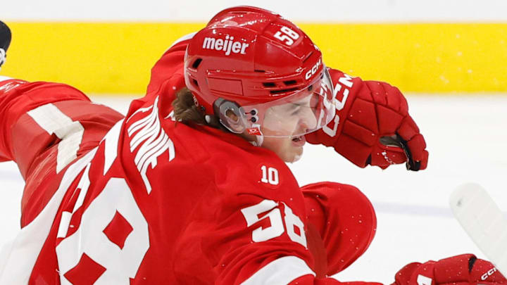 Mar 28, 2026; Detroit, Michigan, USA;  Detroit Red Wings center Emmitt Finnie (58) dives for the puck in the second period against the Philadelphia Flyers at Little Caesars Arena. Mandatory Credit: Rick Osentoski-Imagn Images