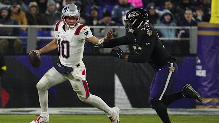 Dec 21, 2025; Baltimore, Maryland, USA;  New England Patriots quarterback Drake Maye (10) runs from Baltimore Ravens linebacker Kyle van Noy (53) during the first half of the game at M&T Bank Stadium. Mandatory Credit: James Lang-Imagn Images