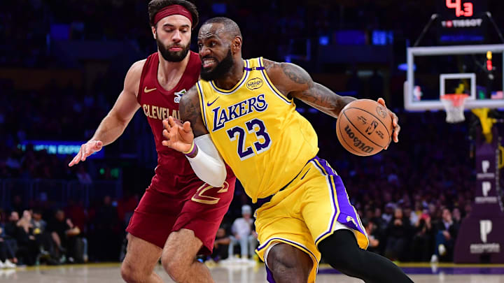 Dec 31, 2024; Los Angeles, California, USA; Los Angeles Lakers forward LeBron James (23) moves to the basket against Cleveland Cavaliers guard Max Strus (1) during the first half at Crypto.com Arena. Mandatory Credit: Gary A. Vasquez-Imagn Images