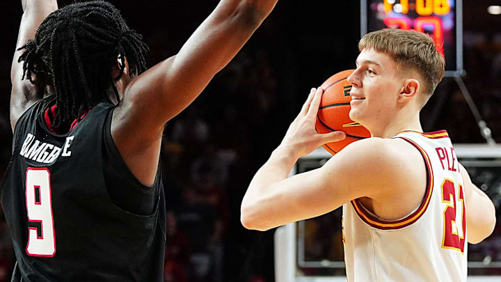 Iowa State Cyclones forward Dominykas Pleta (21) passes the ball around Texas Tech Red Raiders forward Luke Bamgboye (9) during the first half in the Big-12 conference men’s basketball showdown on Feb. 28, 2026, at Hilton Coliseum in Ames, Iowa.