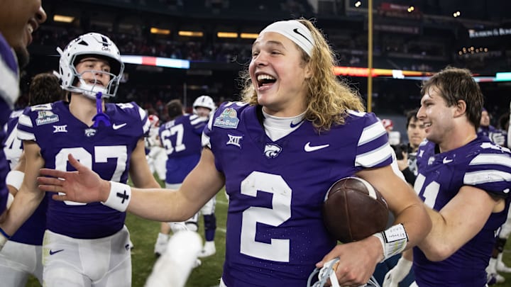 Dec 26, 2024; Phoenix, AZ, USA; Kansas State Wildcats quarterback Avery Johnson (2) celebrates after defeating the Rutgers Scarlet Knights during the Rate Bowl at Chase Field. Mandatory Credit: Mark J. Rebilas-Imagn Images