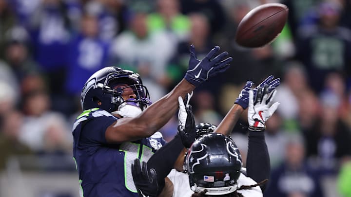 Oct 20, 2025; Seattle, Washington, USA; Seattle Seahawks wide receiver Tory Horton (15) and Houston Texans safety Calen Bullock (2) go up for the ball during the fourth quarter at Lumen Field. Mandatory Credit: Kevin Ng-Imagn Images