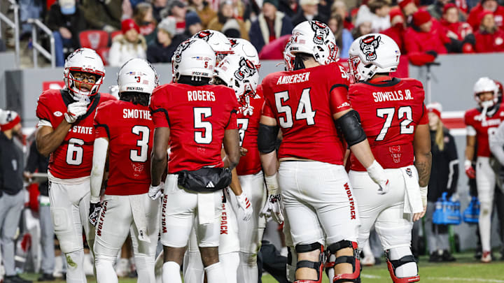Nov 29, 2025; Raleigh, North Carolina, USA;  NC State Wolfpack huddles during the first half of the game against North Carolina Tar Heels at Carter-Finley Stadium.  Mandatory Credit: Jaylynn Nash-Imagn Images