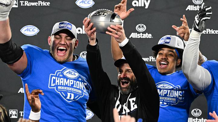 Dec 6, 2025; Charlotte, NC, USA; Duke Blue Devils head coach Manny Diaz lifts the ACC trophy with offensive lineman Justin Pickett (77), quarterback Darian Mensah (10) and defensive tackle Aaron Hall (99) after defeating the Virginia Cavaliers at the 2025 ACC Championship game at Bank of America Stadium. Mandatory Credit: Bob Donnan-Imagn Images